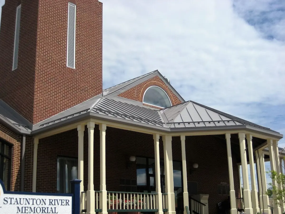 Skilled roofing craftsmen working on a residential roof in Avon